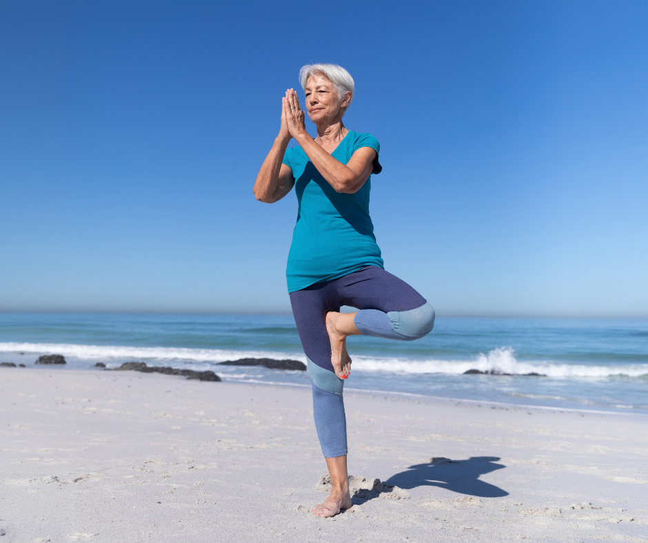 woman doing yoga on the beach